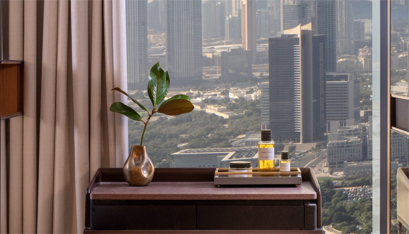 A guest room console at One&Only One Za'abeel, Dubai skyline beyond